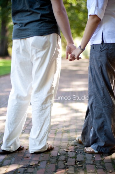 Leah and Greg hold hands on the horseshoe