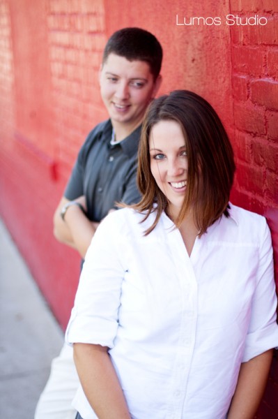 Leah smiles for the camera while Greg looks on