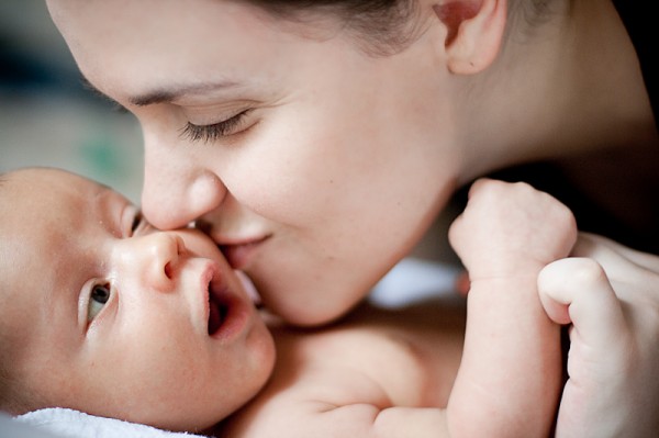 mom kissing baby