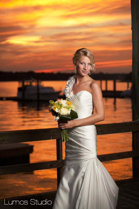 Bride in front of sunset over the water