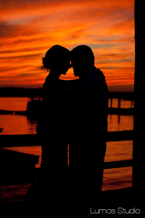 Bride and groom in front of a golden sunset