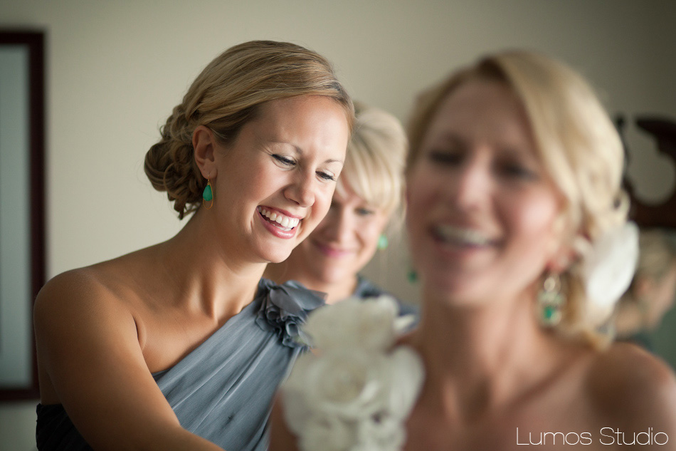 A bridesmaid helps the bride get ready